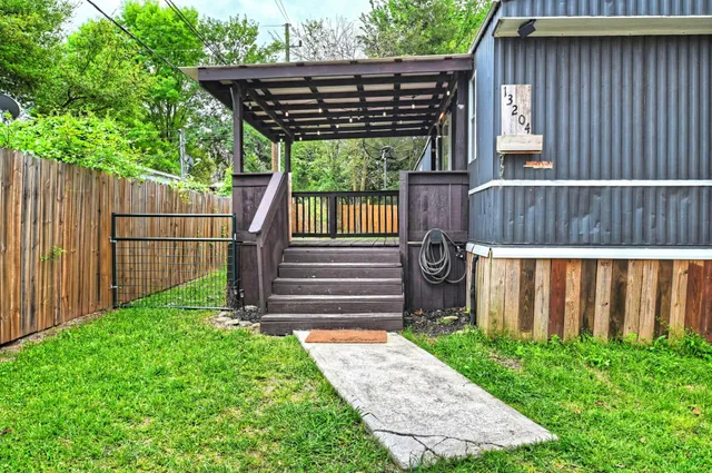 a view of a backyard with wooden fence