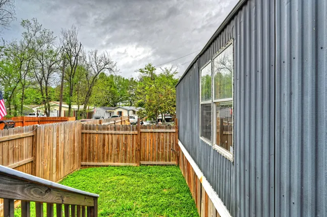 a view of a house with backyard and deck