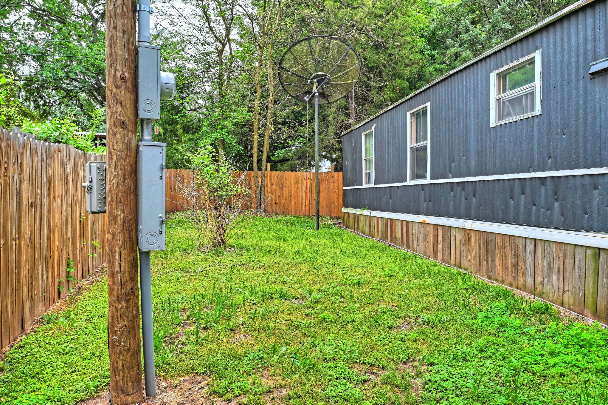 13204 Enchanted Vista Willis, TX 77318 - Photo 5 of 43 a view of backyard with large trees and wooden fence