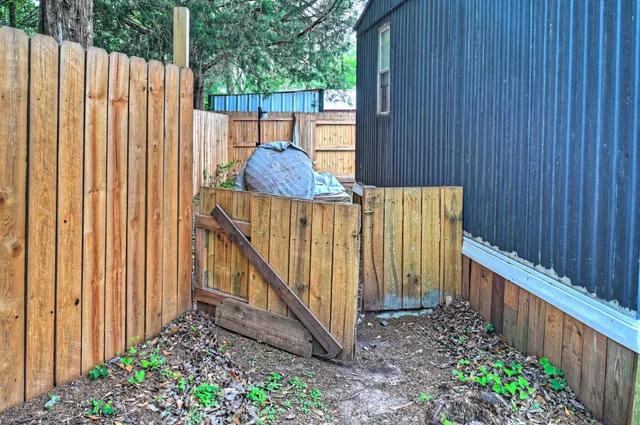 a view of a house with wooden fence