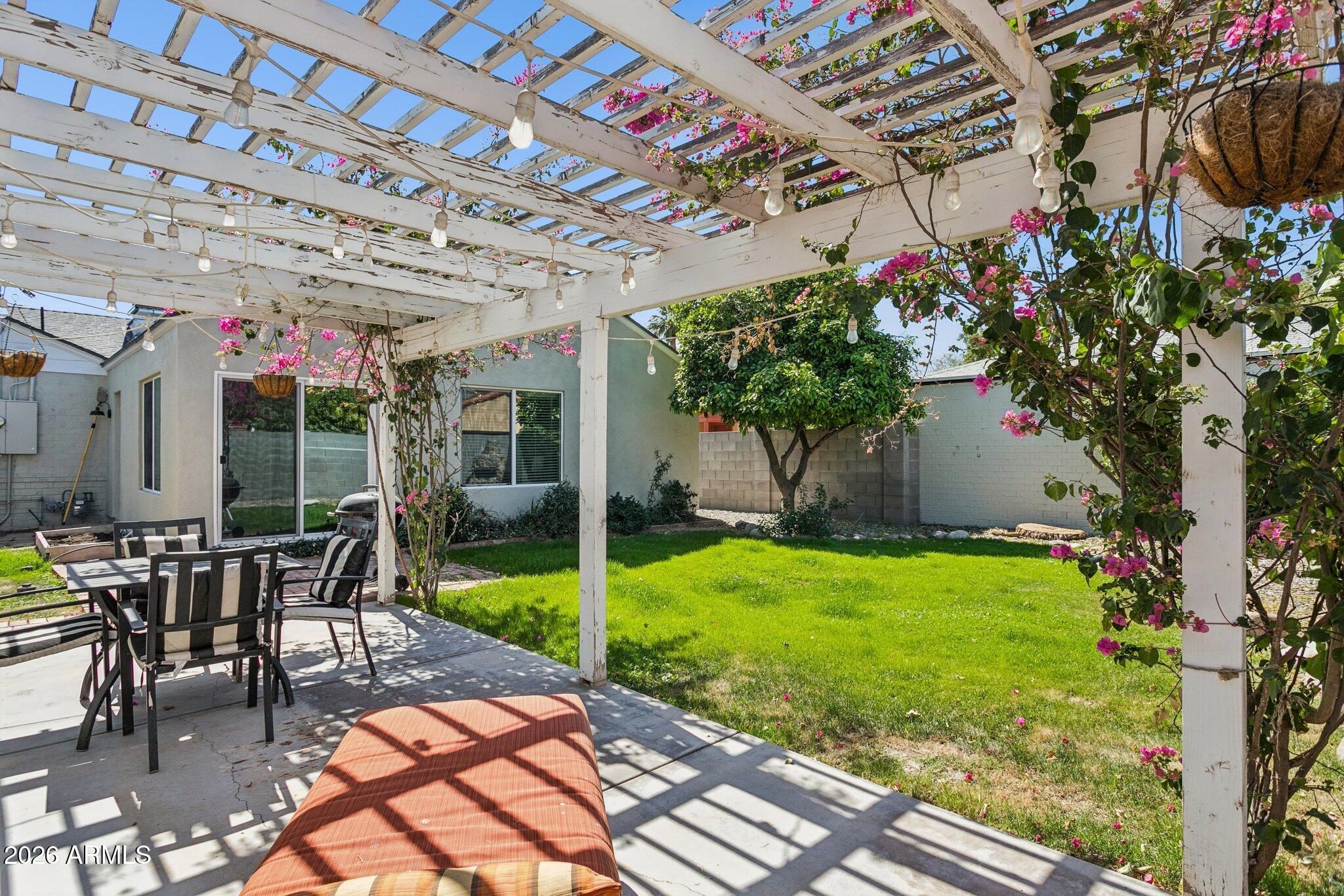 322 West Coronado Road Phoenix, AZ 85003 - Photo 74 of 93 a view of a patio with table and chairs potted plants and large tree