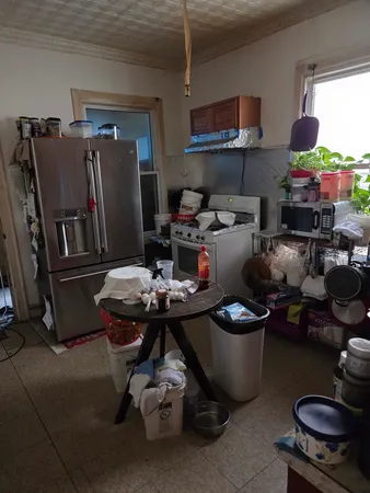 a kitchen with a sink a stove and chairs
