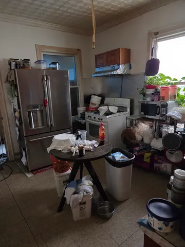 a kitchen with a sink a stove and chairs
