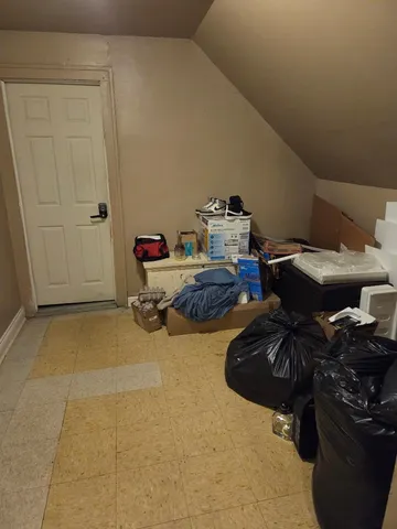 a bedroom with furniture and a air conditioner vent