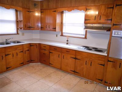1111 Ridge Avenue Allentown, PA 18102 - Photo 5 of 10 a kitchen with a sink stove and cabinets