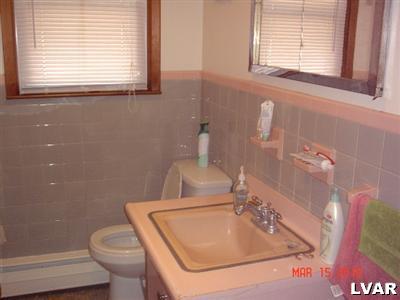 1111 Ridge Avenue Allentown, PA 18102 - Photo 6 of 10 a bathroom with a sink a toilet and a window