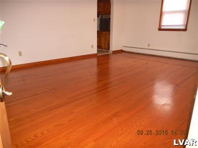 1111 Ridge Avenue Allentown, PA 18102 - Photo 7 of 10 an empty room with wooden floor and windows