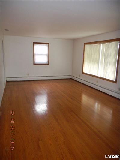 1111 Ridge Avenue Allentown, PA 18102 - Photo 8 of 10 an empty room with wooden floor and windows