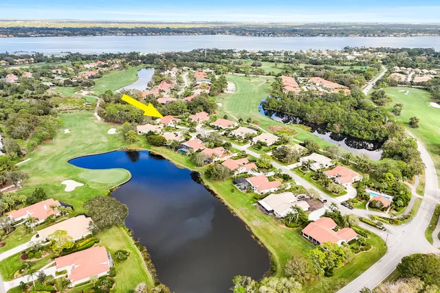 an aerial view of residential houses with outdoor space and swimming pool