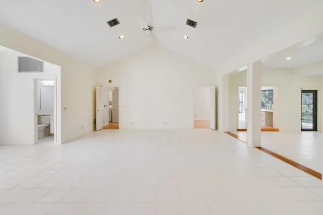 a dining room with furniture a chandelier and wooden floor