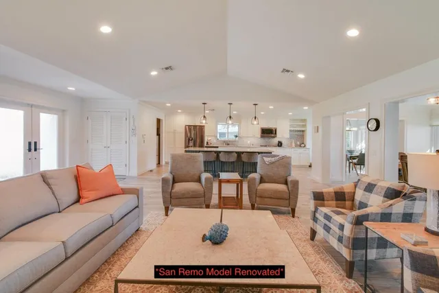 a view of room with a large window and front door