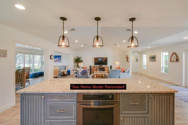 a large kitchen with stainless steel appliances kitchen island granite countertop a large counter top and sink