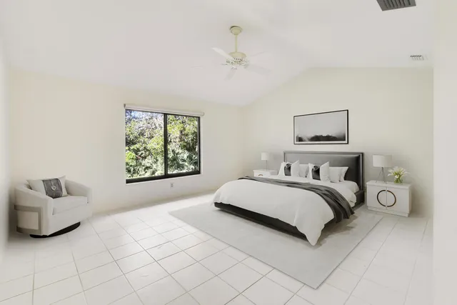 a view of a garden with a tree in front of the house