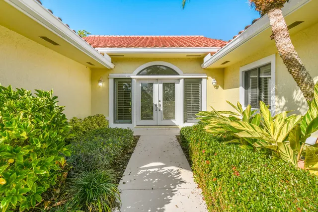 a living room with furniture a flat screen tv and a table