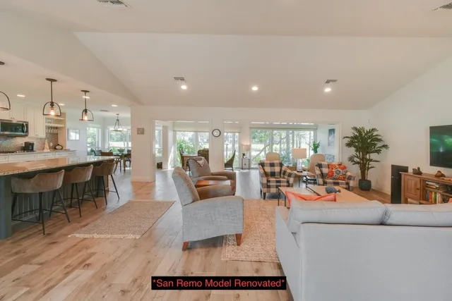 a kitchen with white cabinets and black appliances