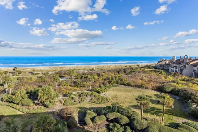 a kitchen with granite countertop a refrigerator and a sink