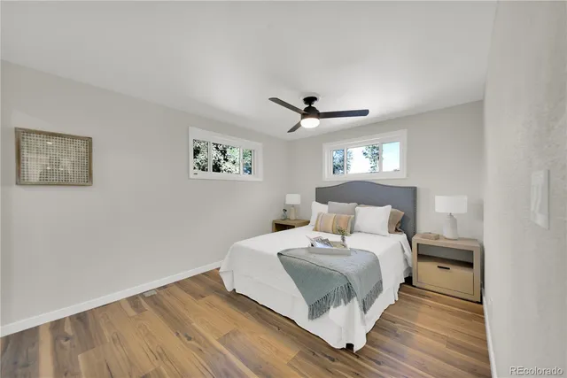 a bedroom with a large bed and a ceiling fan