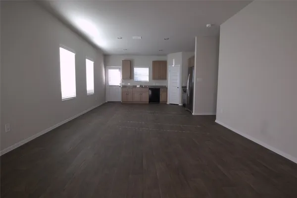 an empty room with windows and closet