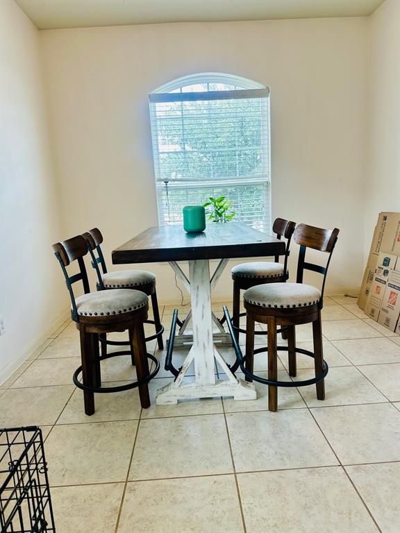 111 Rebel Road Venus, TX 76084 - Photo 5 of 7 Room featuring a large arched window with blinds, neutral wall paint, and tile flooring