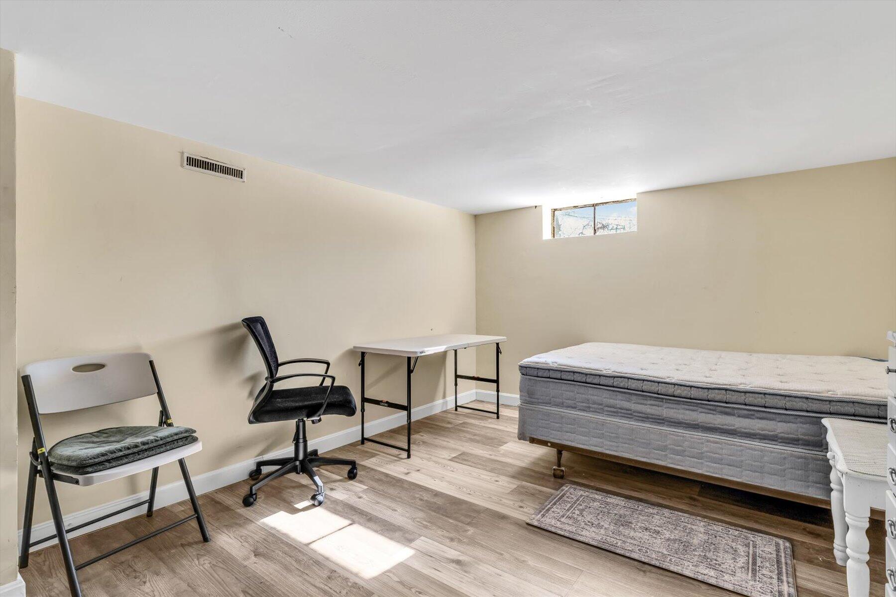97 Bassett Lane Hyannis, MA 02601 - Photo 18 of 24 a bedroom with a chair and a couch