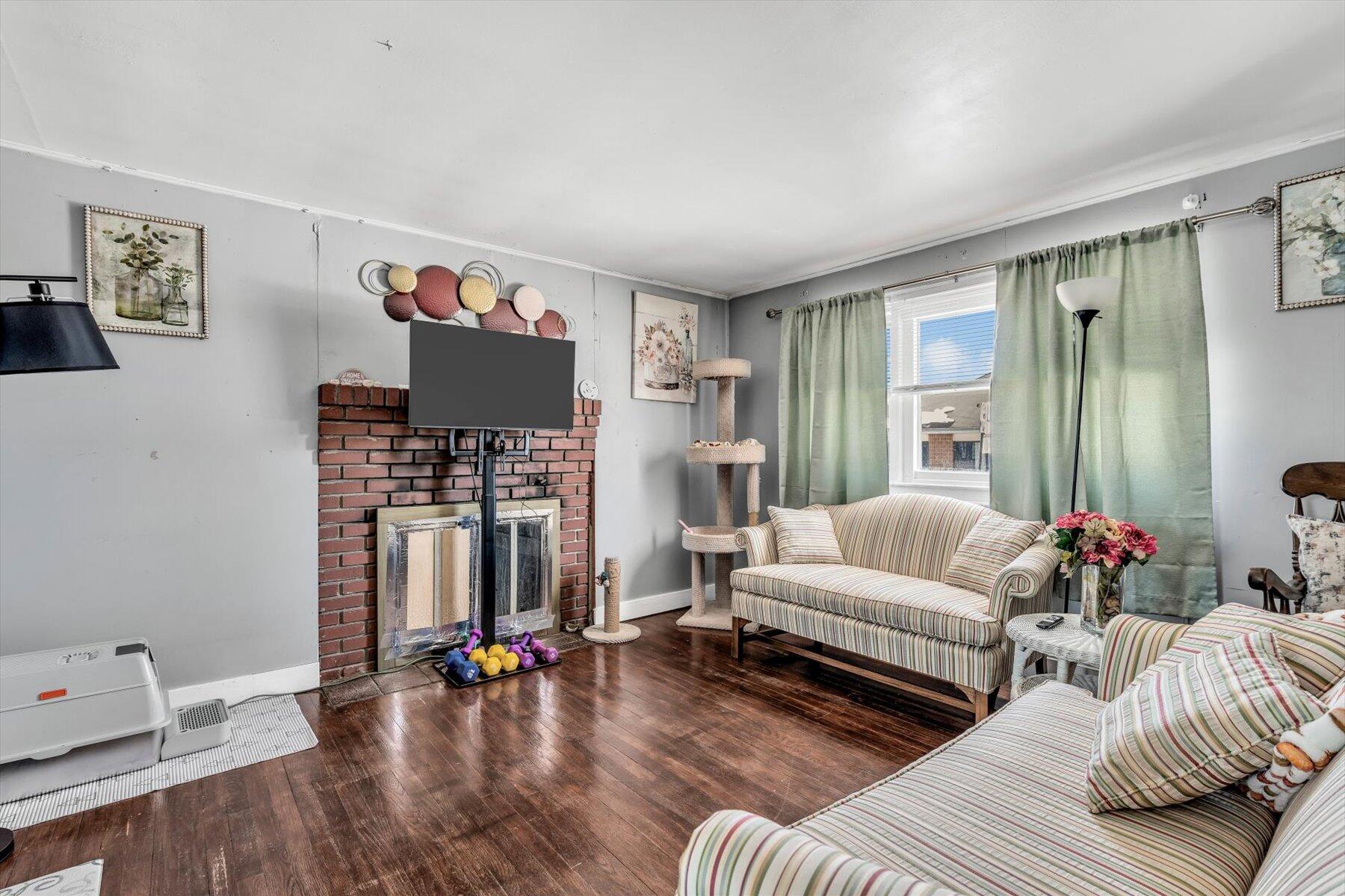 97 Bassett Lane Hyannis, MA 02601 - Photo 3 of 24 a living room with furniture and a wooden floor