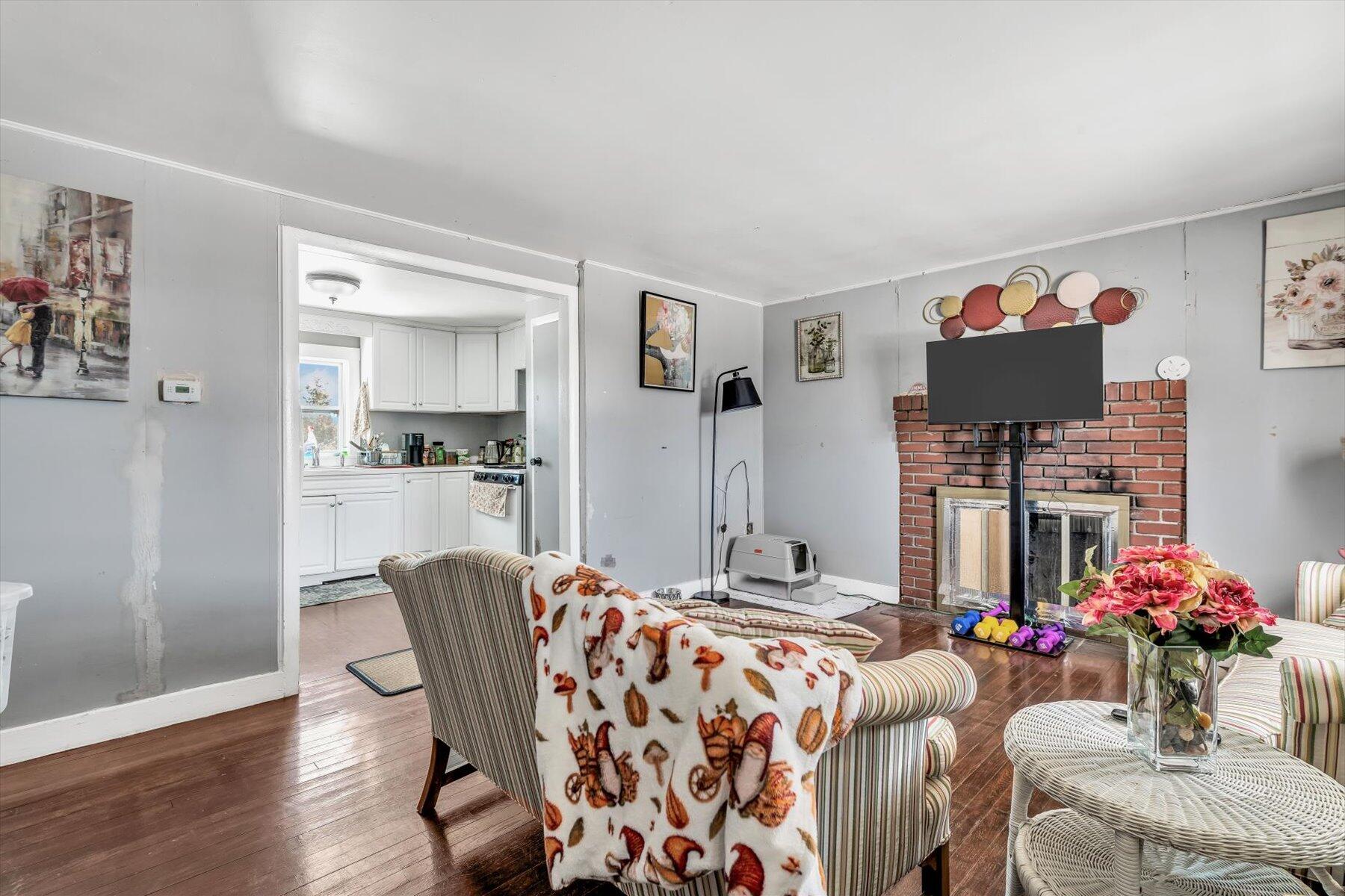 97 Bassett Lane Hyannis, MA 02601 - Photo 5 of 24 a living room with furniture and flowers