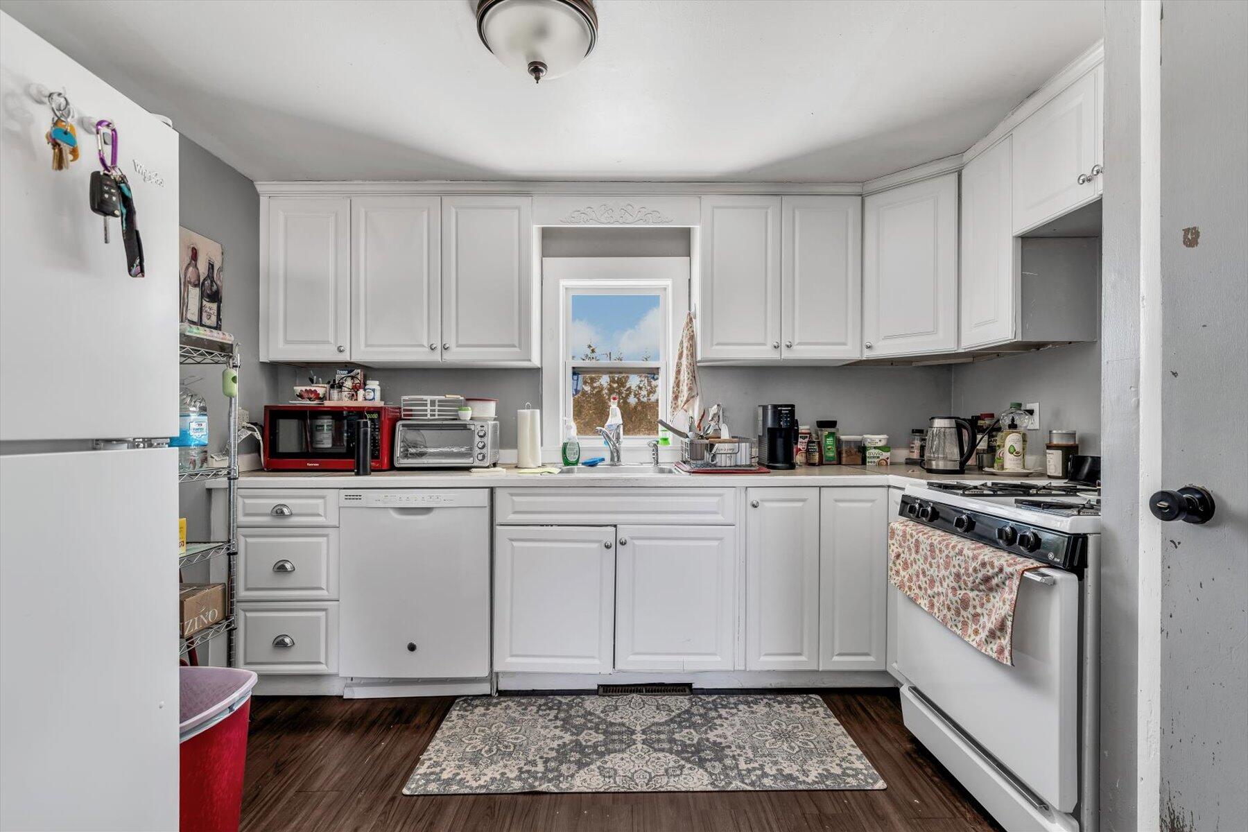 97 Bassett Lane Hyannis, MA 02601 - Photo 6 of 24 a kitchen with stainless steel appliances granite countertop a refrigerator sink and white cabinets