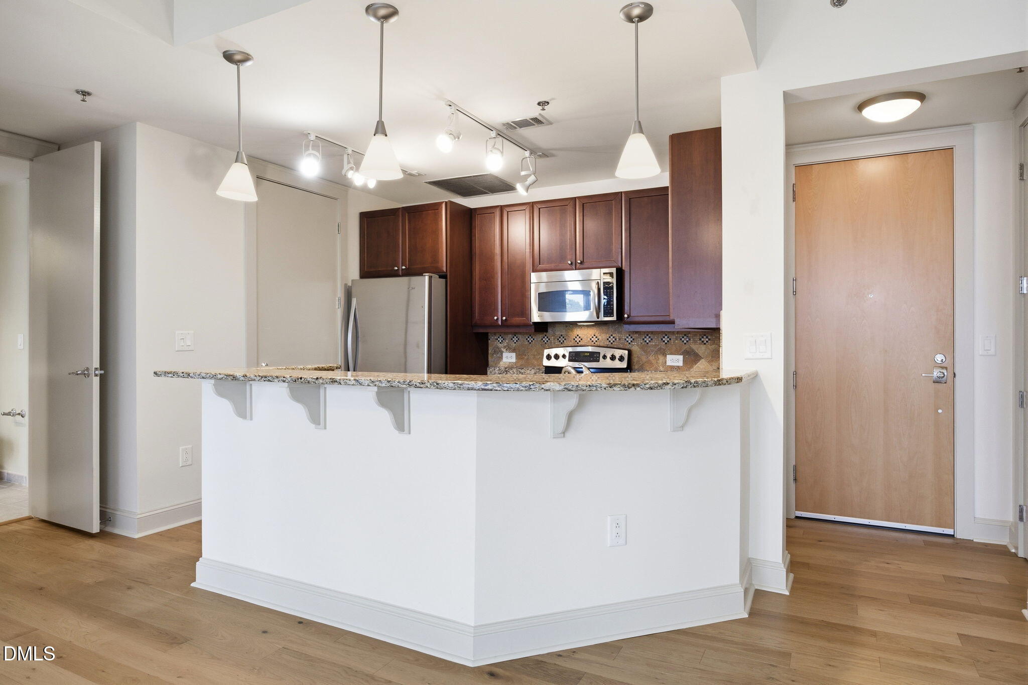 618 North Boylan Avenue, Unit 800 Raleigh, NC 27603 - Photo 3 of 25 a view of a kitchen with a refrigerator a microwave and a sink