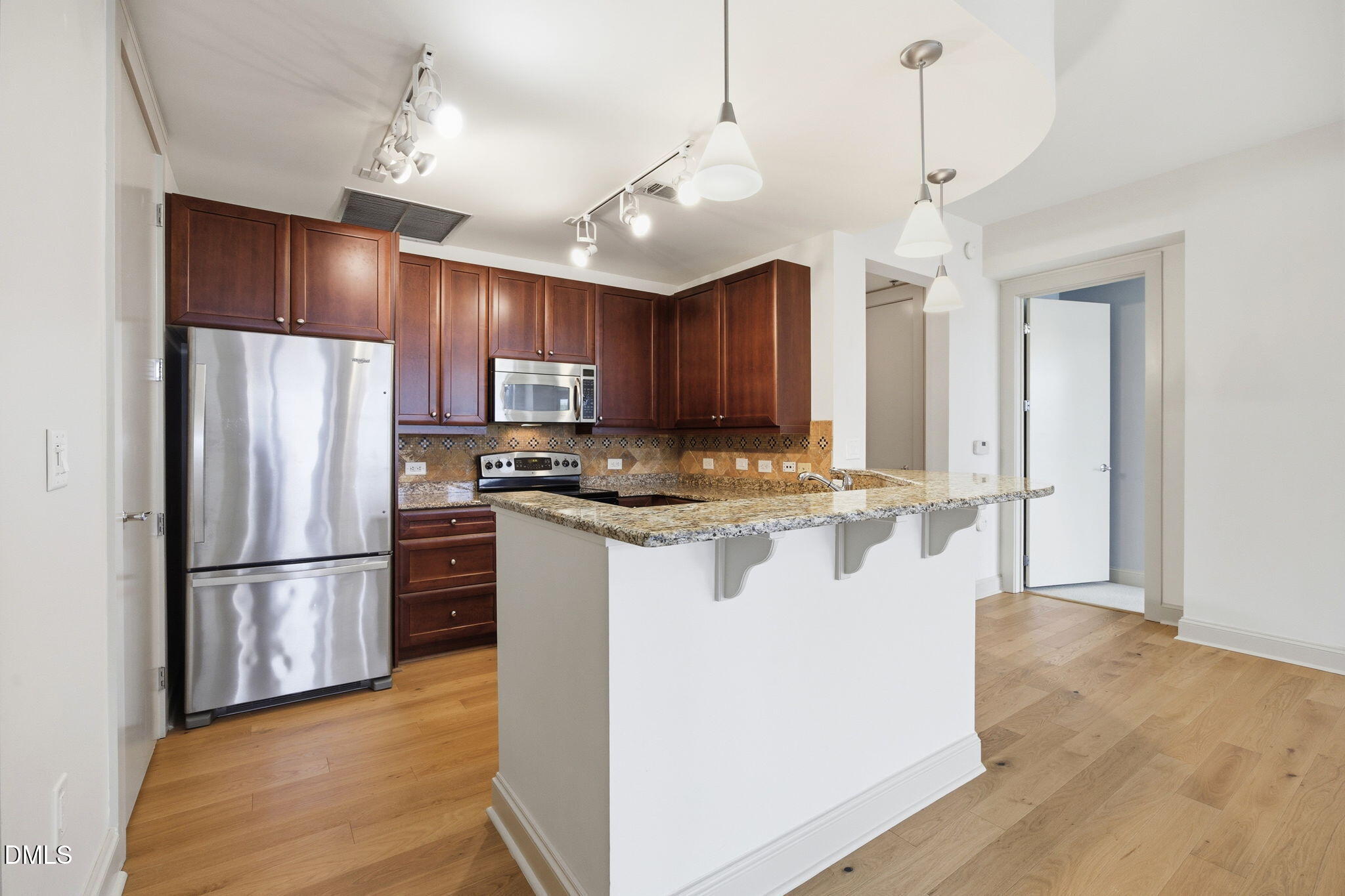 618 North Boylan Avenue, Unit 800 Raleigh, NC 27603 - Photo 4 of 25 a kitchen with stainless steel appliances granite countertop a refrigerator a sink dishwasher a stove and a refrigerator with wooden floor