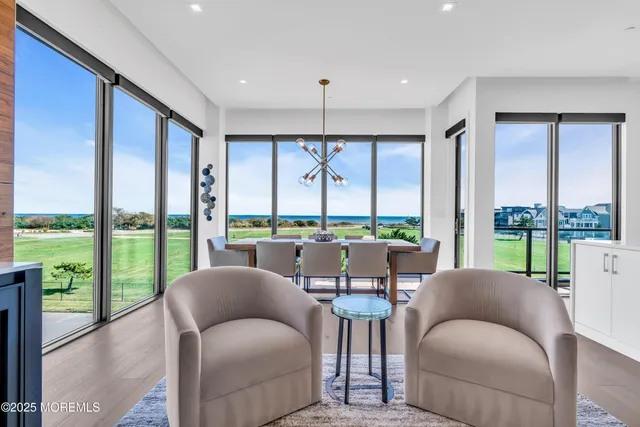 a living room with a large window and furniture