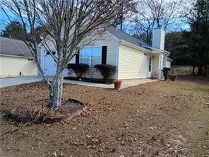 a view of a house with a yard covered in snow
