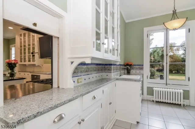 a kitchen with a stove a sink and a granite counter tops