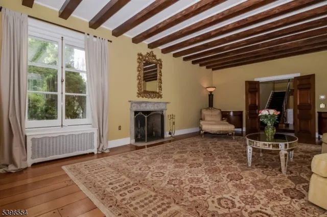 a living room with furniture a fireplace and next to a window