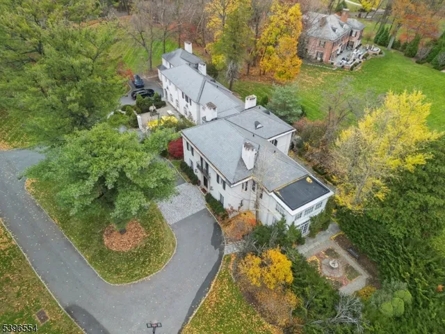 an aerial view of a house with a yard swimming pool and outdoor seating