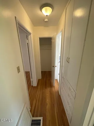 a view of a hallway with wooden floor and staircase