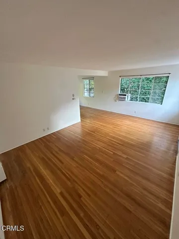 an empty room with wooden floor