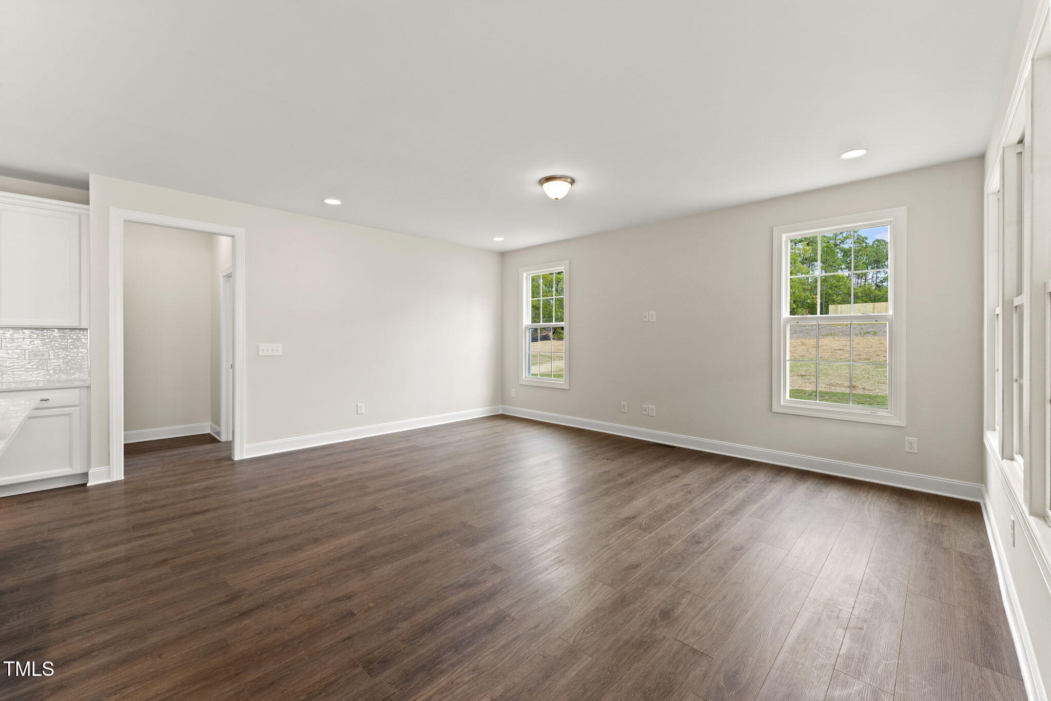 134 Ivy Rdg Road Chapel Hill, NC 27516 - Photo 14 of 37 an empty room with wooden floor and windows