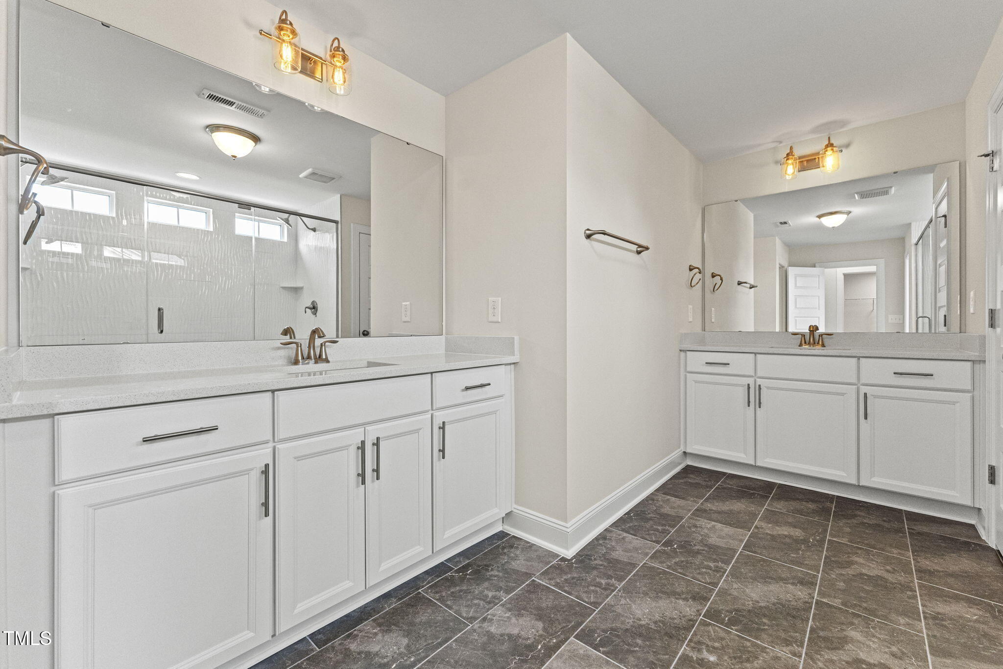 134 Ivy Rdg Road Chapel Hill, NC 27516 - Photo 24 of 37 a spacious bathroom with a mirror sink and cabinets