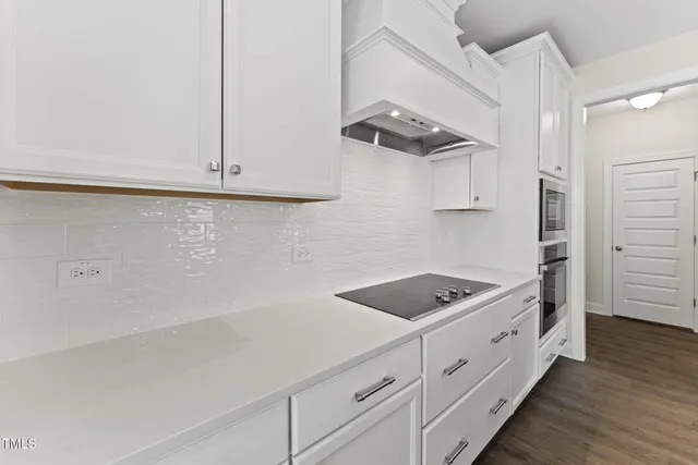 a kitchen with cabinets and window