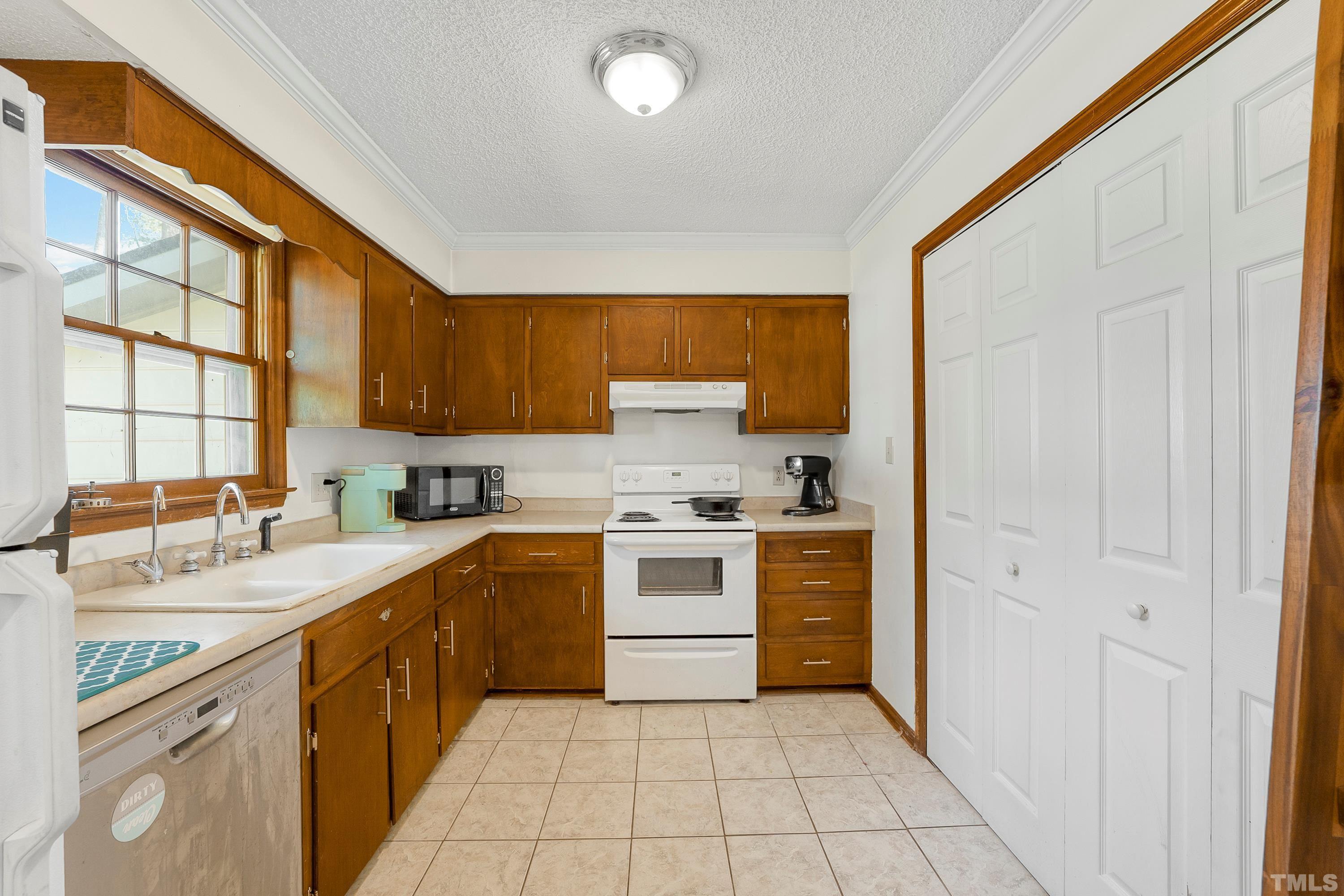 6301 Poole Road Raleigh, NC 27610 - Photo 5 of 20 a kitchen with a stove a sink and a microwave