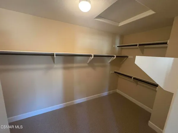 a spacious bathroom with a double vanity sink a mirror and a shower