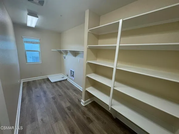 a view of a room with wooden floor