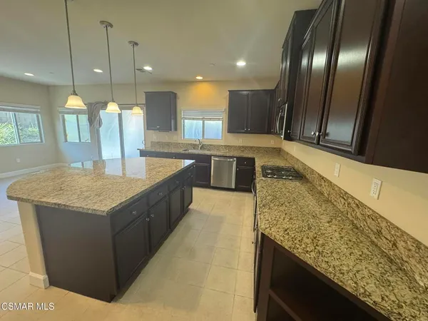 a large kitchen with kitchen island a sink counter top space