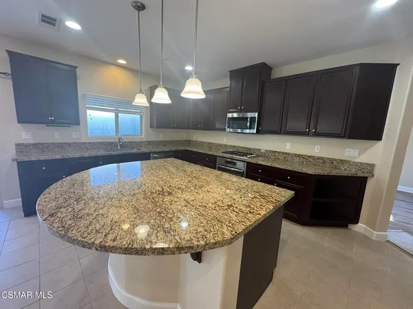a kitchen with a sink and a wooden cabinets