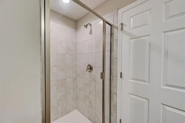 a bathroom with a glass shower door