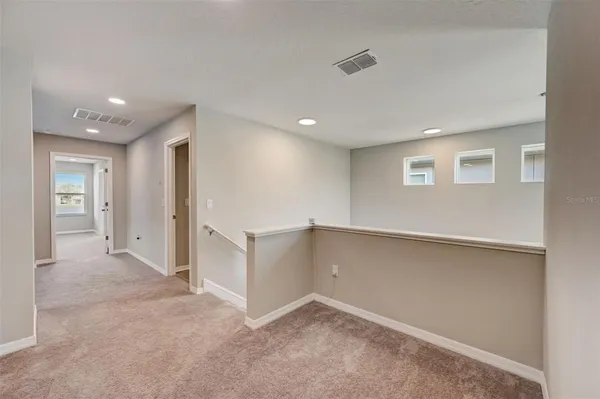 an empty room with a cabinet and mirrors