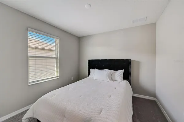 a bedroom with a bed and window