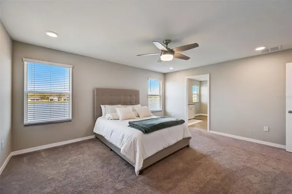 a spacious bedroom with a bed and a window