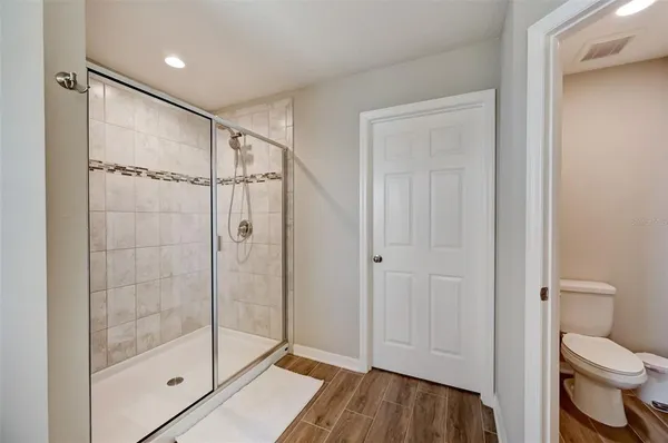 a bathroom with a shower a toilet and a sink