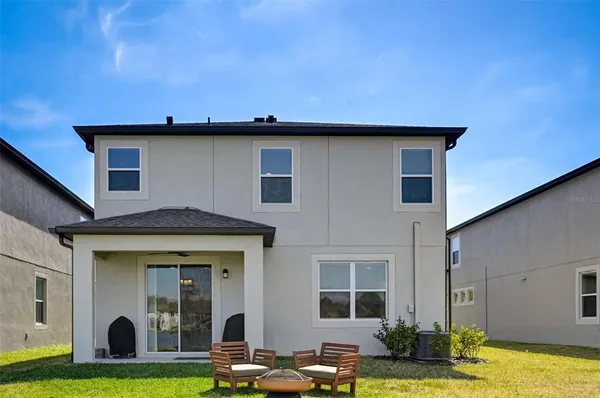 a view of a house with swimming pool in front of it